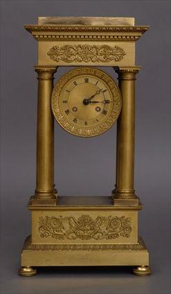 Appraisal: CHARLES X GILT-BRONZE PILLAR CLOCK The dial within leaf-tip and