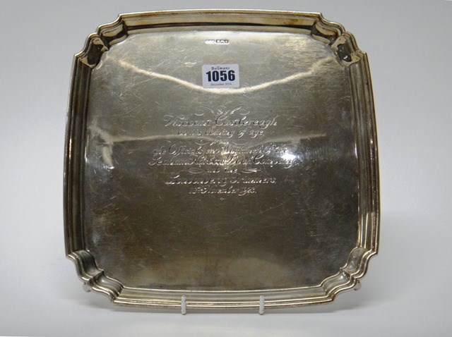 Appraisal: A silver shaped square salver presentation inscribed to the centre