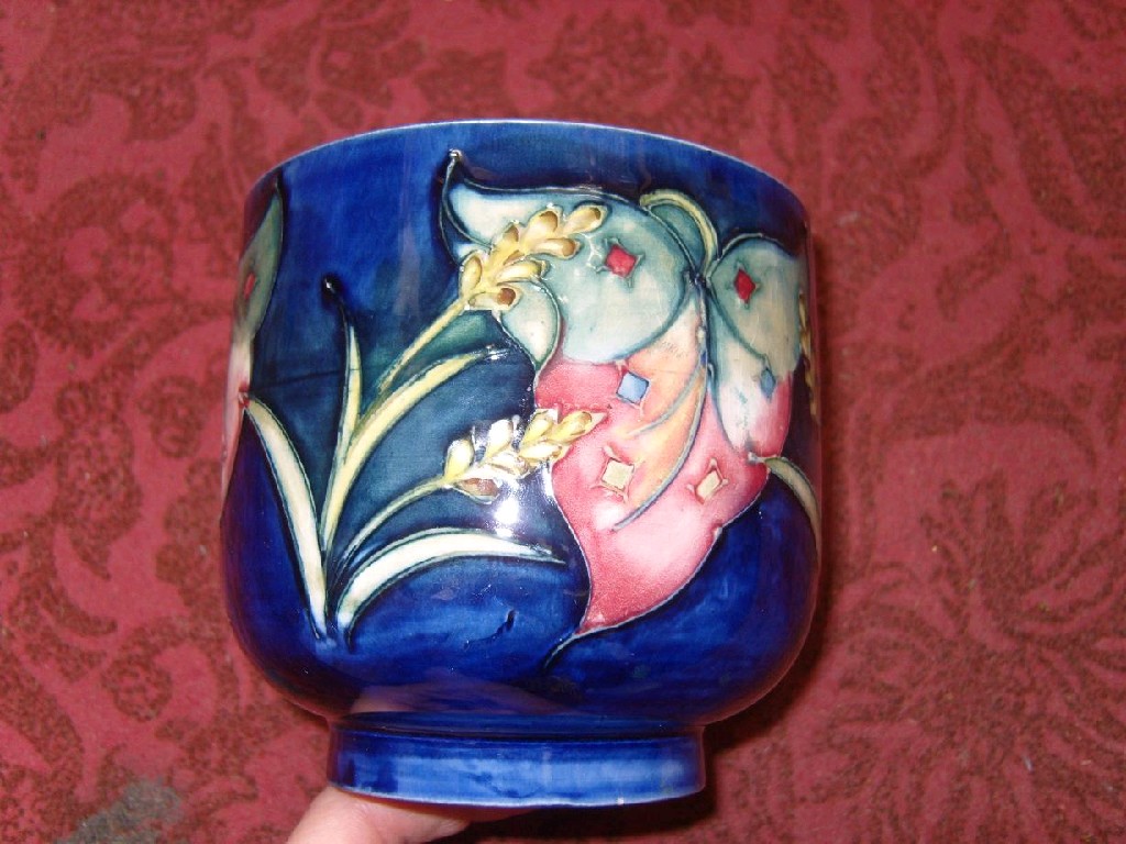 Appraisal: A Moorcroft blue ground small cachepot with painted leaf and