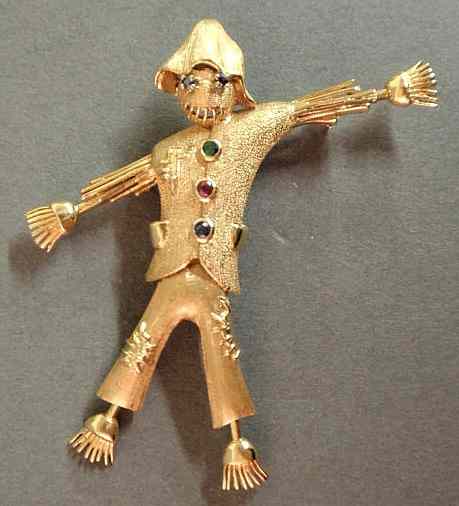 Appraisal: Gold scarecrow brooch k yg with blue sapphire eyes and