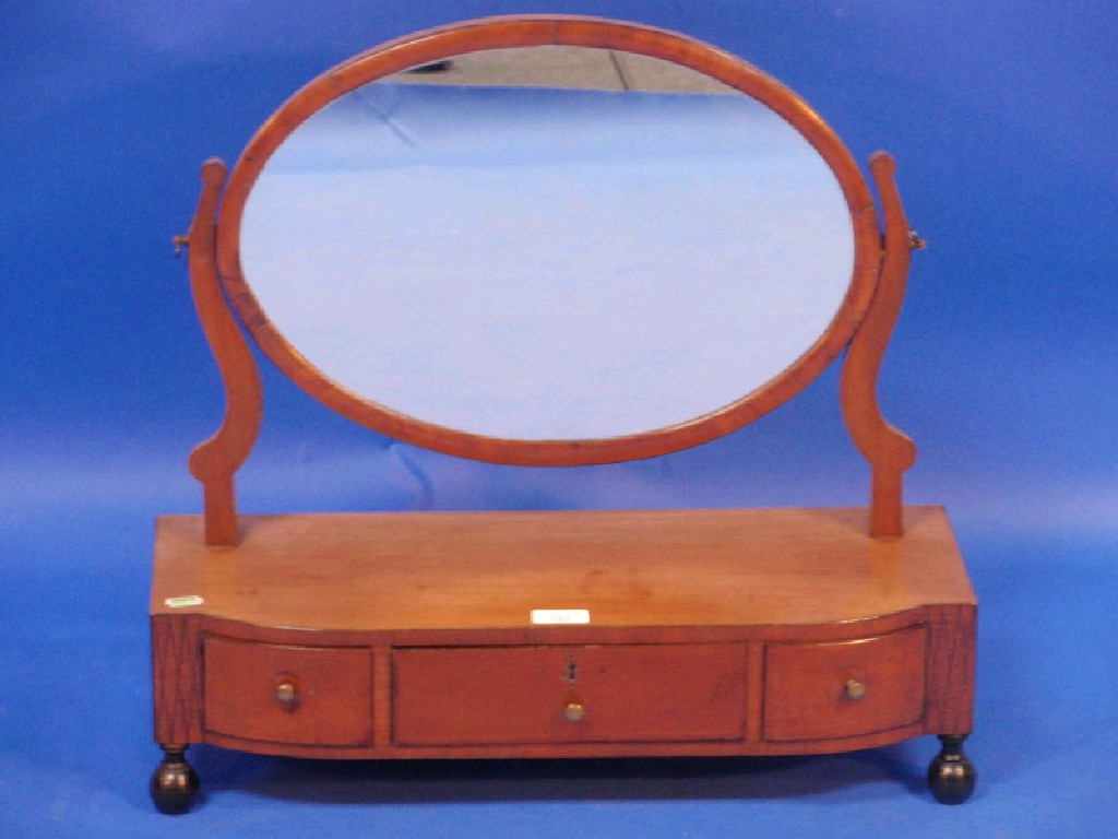 Appraisal: A Georgian mahogany oval toilet mirror the stand fitted with