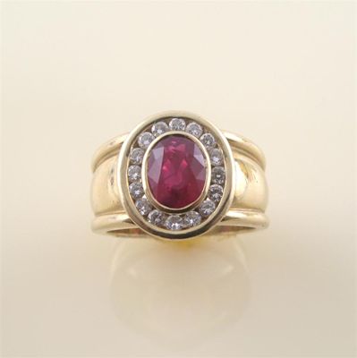 Appraisal: A ruby and diamond cluster ring the oval shaped ruby