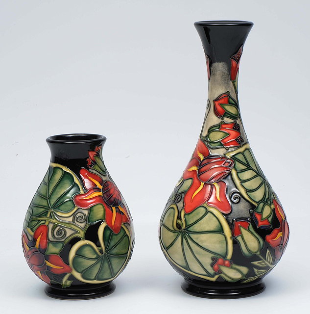 Appraisal: A CONTEMPORARY MOORCROFT BOTTLE VASE decorated with red and yellow