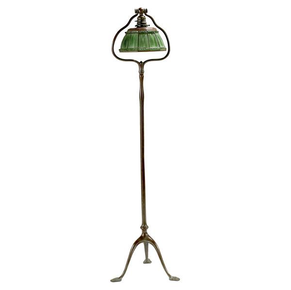 Appraisal: TIFFANY STUDIOSBronze tripod base floor lamp with green curtain glass