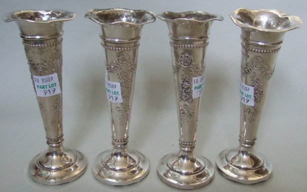 Appraisal: A set of four silver trumpet shaped flower vases each