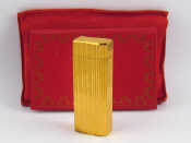 Appraisal: Cartier A gold plated cigarette lighter by Cartier in pouch