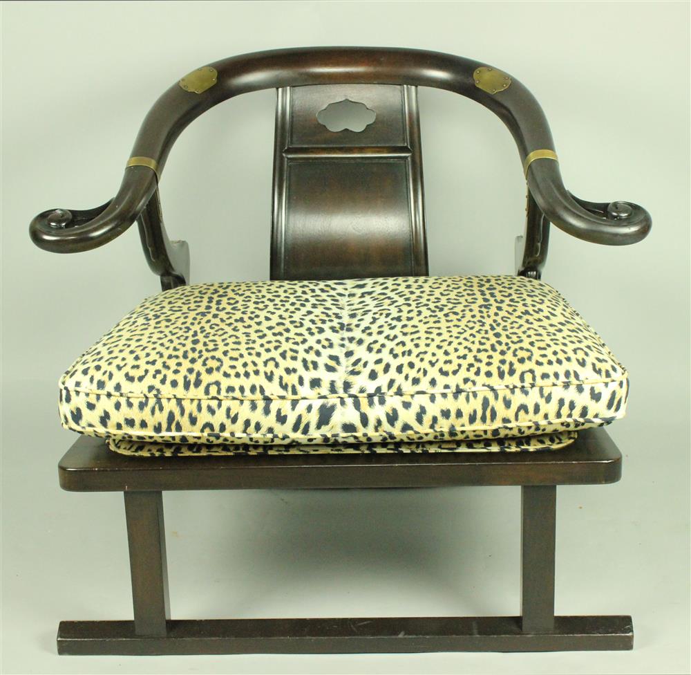 Appraisal: CHINESE STYLE EBONIZED LOW ARMCHAIR WITH LEOPARD UPHOLSTERY having a