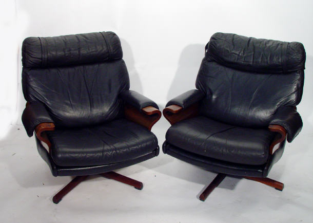 Appraisal: 's Australian rosewood swivel armchair with black leather seat and