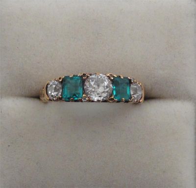 Appraisal: An emerald and diamond five stone ring Set with three