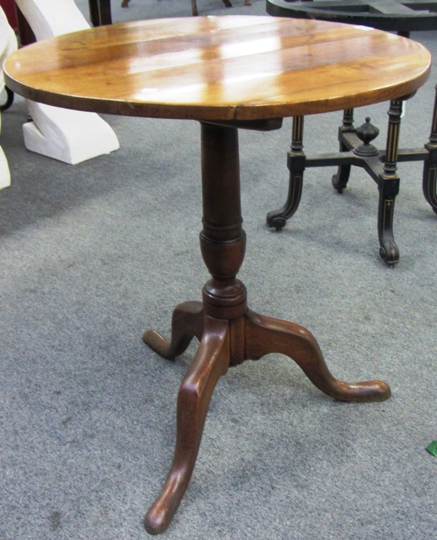 Appraisal: A George III fruitwood circular snap top tripod table cm