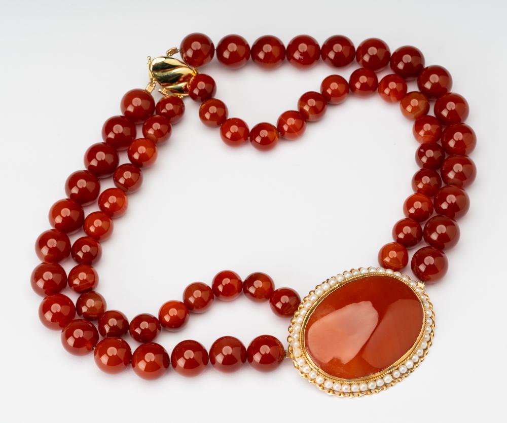 Appraisal: CARNELIAN PEARL NECKLACEThe double-strand necklace set with one oval cabochon