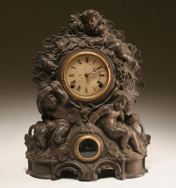 Appraisal: Cast iron clock embossed with cherubs grape vine detail wood