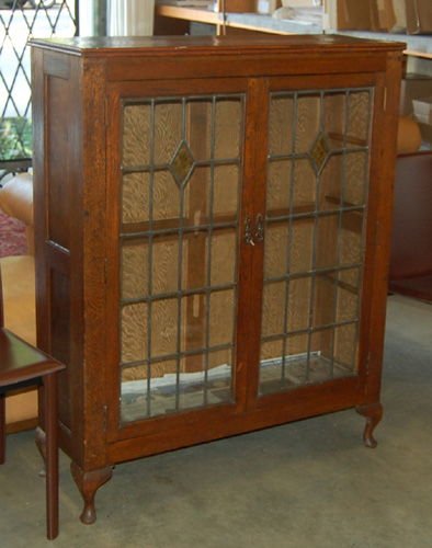 Appraisal: AN OAK AND LEADED GLASS DISPLAY CABINET English c having