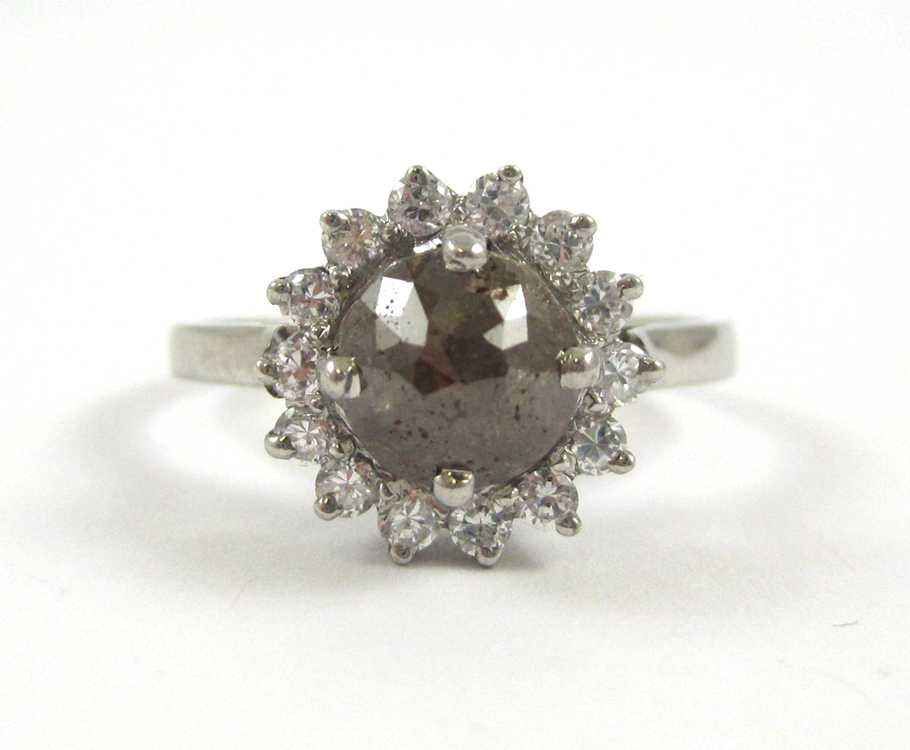 Appraisal: CHOCOLATE DIAMOND AND WHITE ZIRCON RING The silver ring with