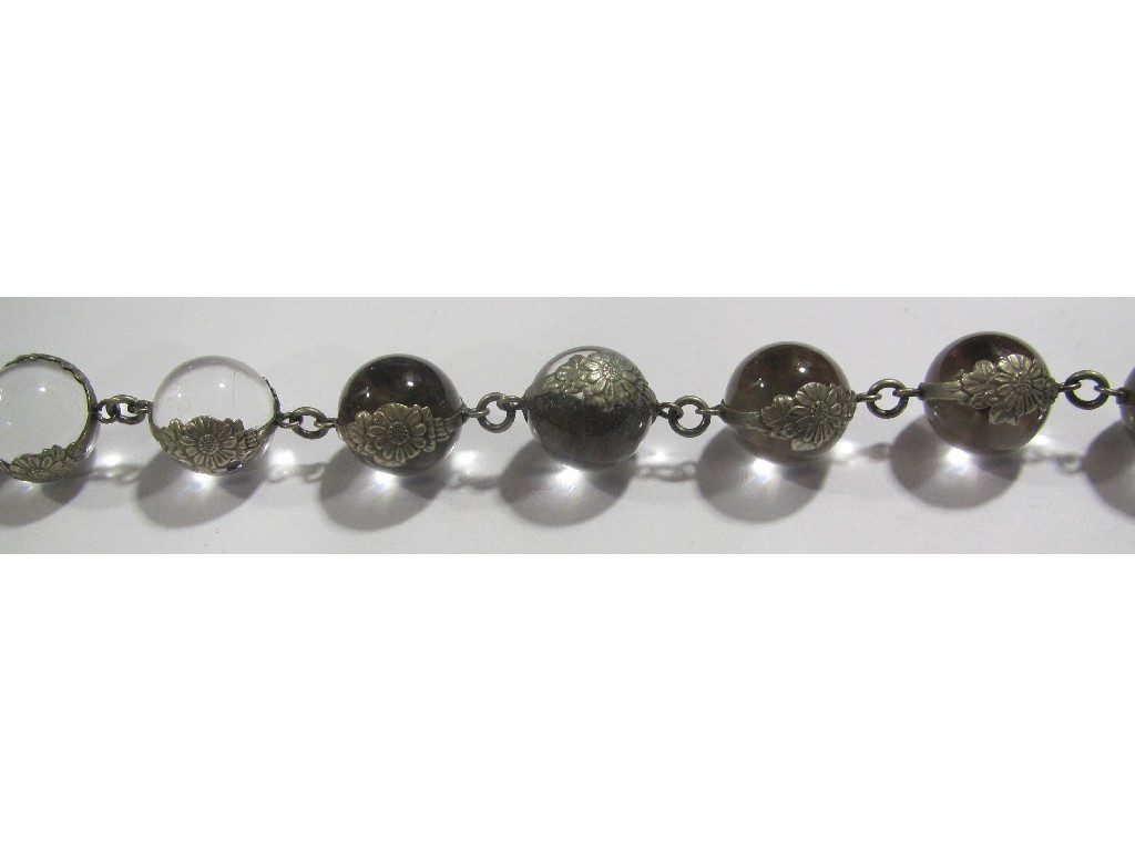 Appraisal: String of round glass beads each with a white metal