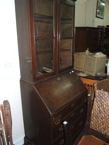 Appraisal: An th Century oak bureau bookcase the upper section fitted