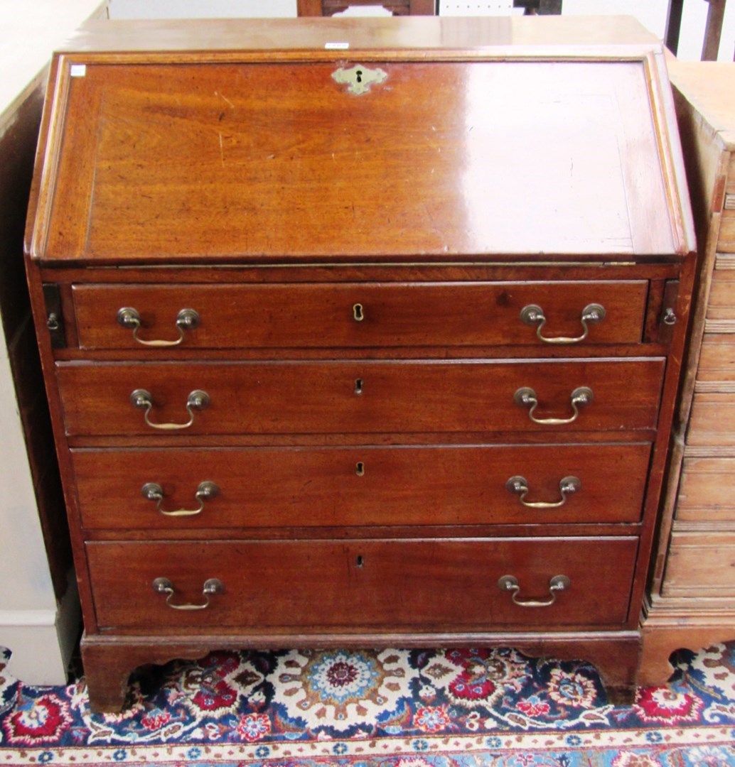 Appraisal: A George III mahogany bureau the fitted interior over four