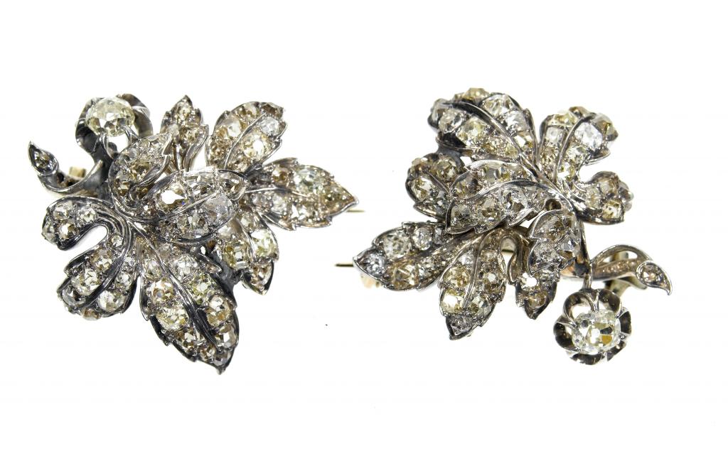 Appraisal: A PAIR OF DIAMOND LEAF-SHAPED BROOCHES with round and cushion