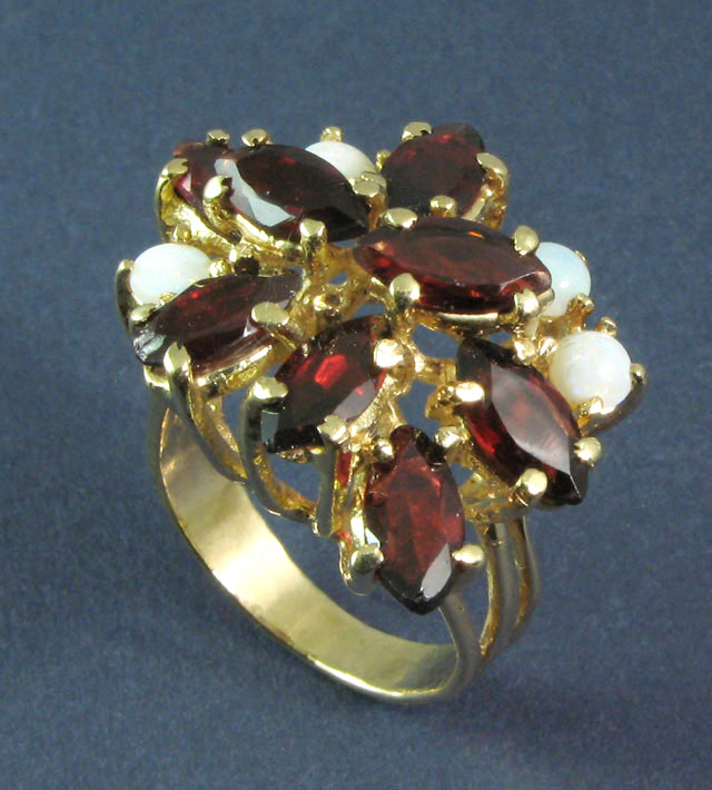 Appraisal: GARNET OPAL AND TEN KARAT GOLD RING set with eight