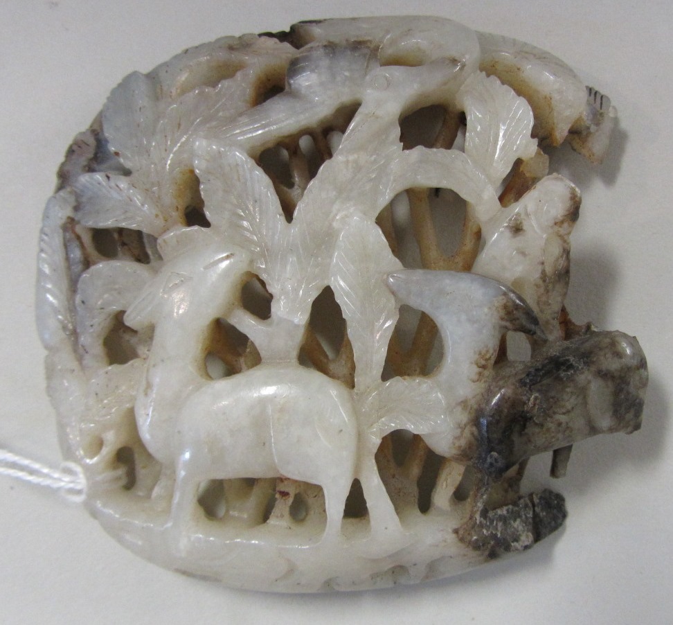 Appraisal: A Chinese grey and russet jade openwork plaque possibly Yuan