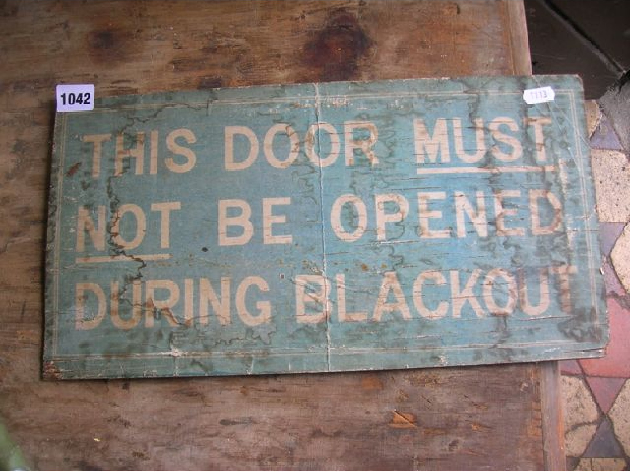 Appraisal: A small rectangular plywood sign reading This Door Must Not