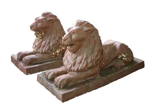 Appraisal: A pair of terracotta recumbent lions on rectangular bases each