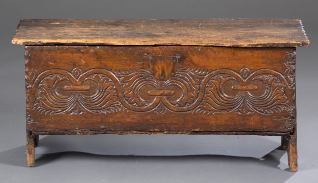 Appraisal: thc Carved English Chest Heavily carved leaf and scroll motif