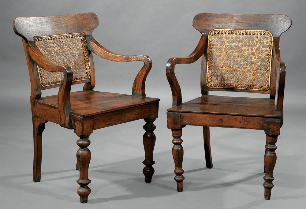 Appraisal: Pair of Anglo-Colonial Carved Tropical Hardwood Armchairs th c shaped