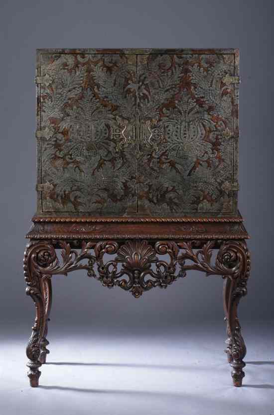 Appraisal: CONTINENTAL TOOLED LEATHER CABINET-ON-STAND late th century Elaborately embellished two-door