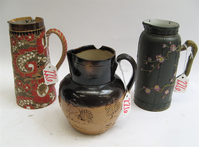 Appraisal: THREE ENGLISH POTTERY PITCHERS Two Doulton Lambeth one hand enameled