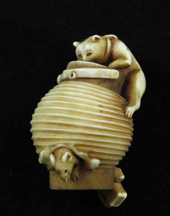 Appraisal: An ivory netsuke carved as a cat hunting a mouse