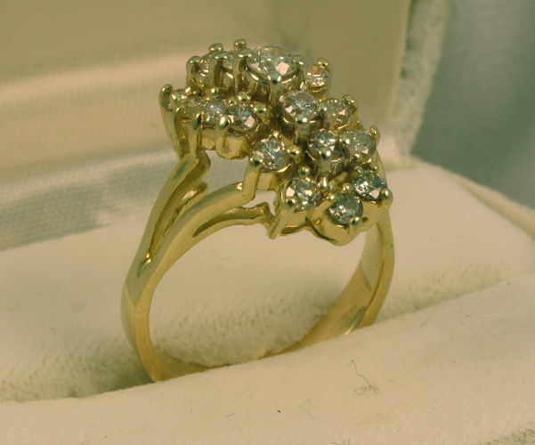 Appraisal: DIAMOND AND FOURTEEN KARAT GOLD CLUSTER RING set with round-cut