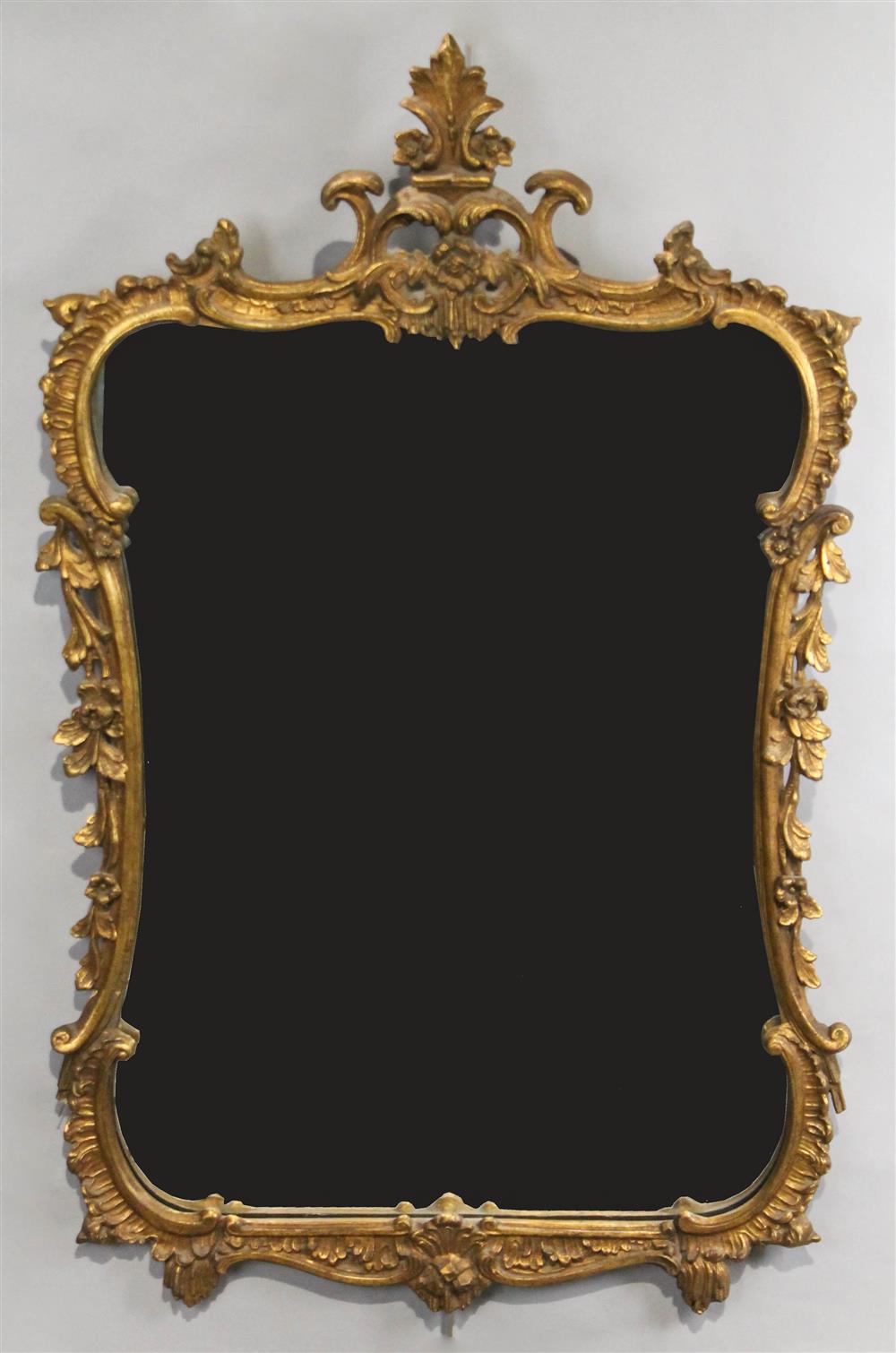 Appraisal: ROCOCO STYLE GILTWOOD FRAME MIRROR the scrolling foliate frame with