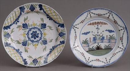 Appraisal: TWO ENGLISH DELFT POLYCHROME CHARGERS The one with fenced garden