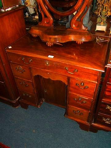 Appraisal: A George III and later mahogany kneehole desk with central