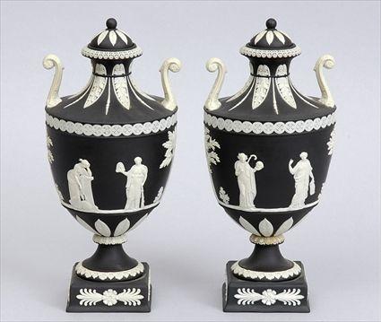 Appraisal: PAIR OF WEDGWOOD BLACK JASPERWARE TWO-HANDLED URNS AND COVERS Each