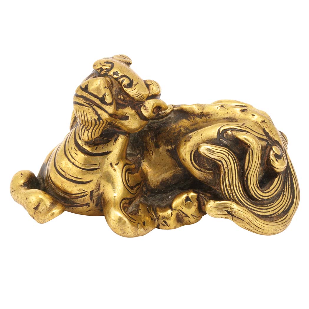 Appraisal: Chinese Gilt-Bronze Qilin Weight Ming Dynasty The sinuous animal lying