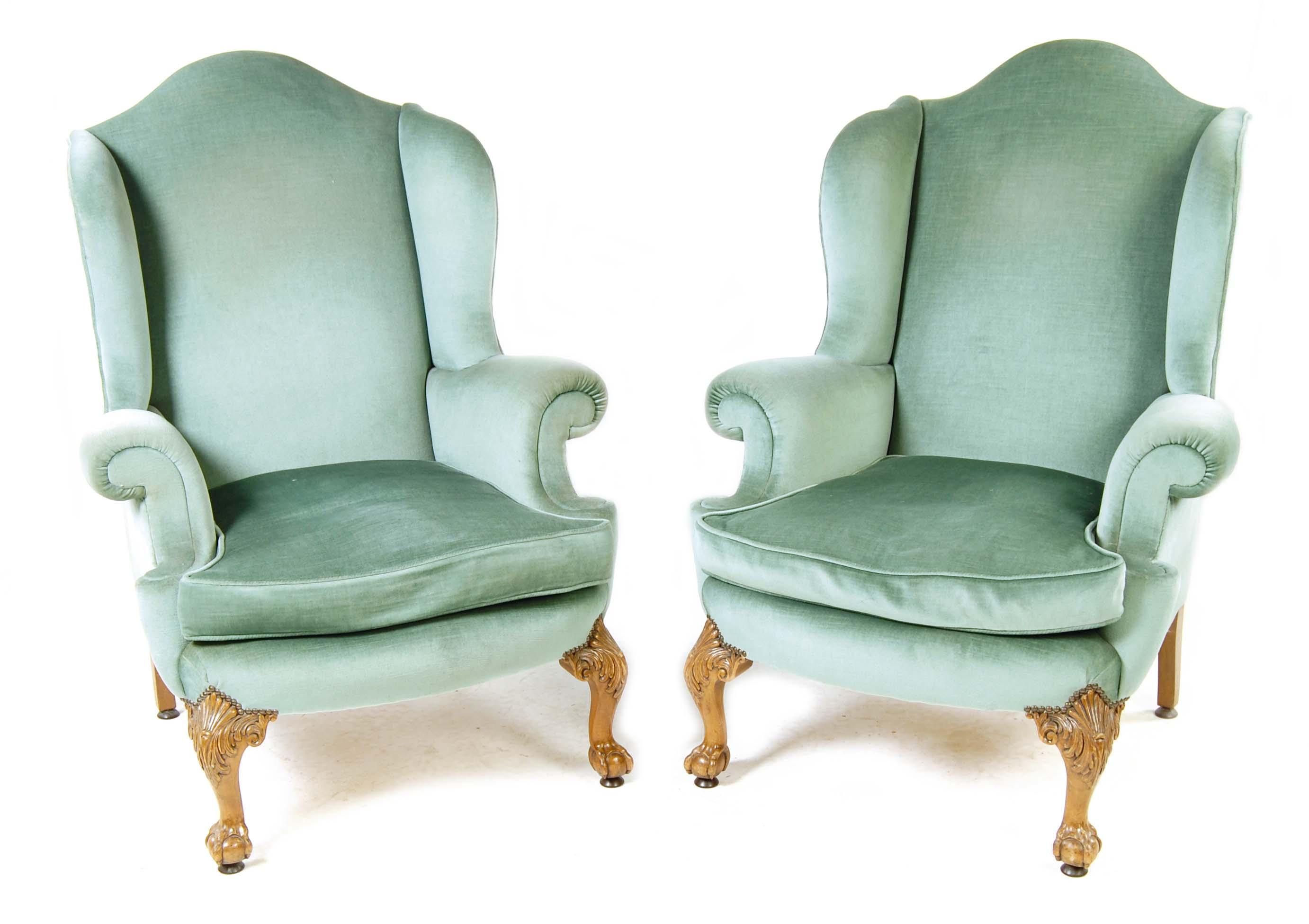 Appraisal: A pair of walnut wing armchairs in George II style