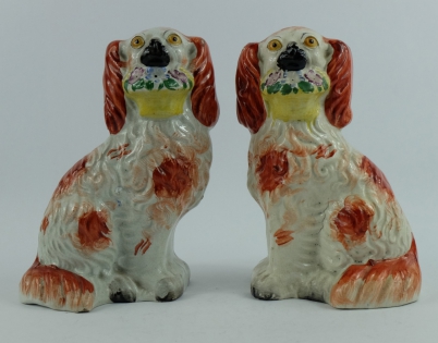 Appraisal: Pair th century Staffordshire seated spaniels with basket of flowers