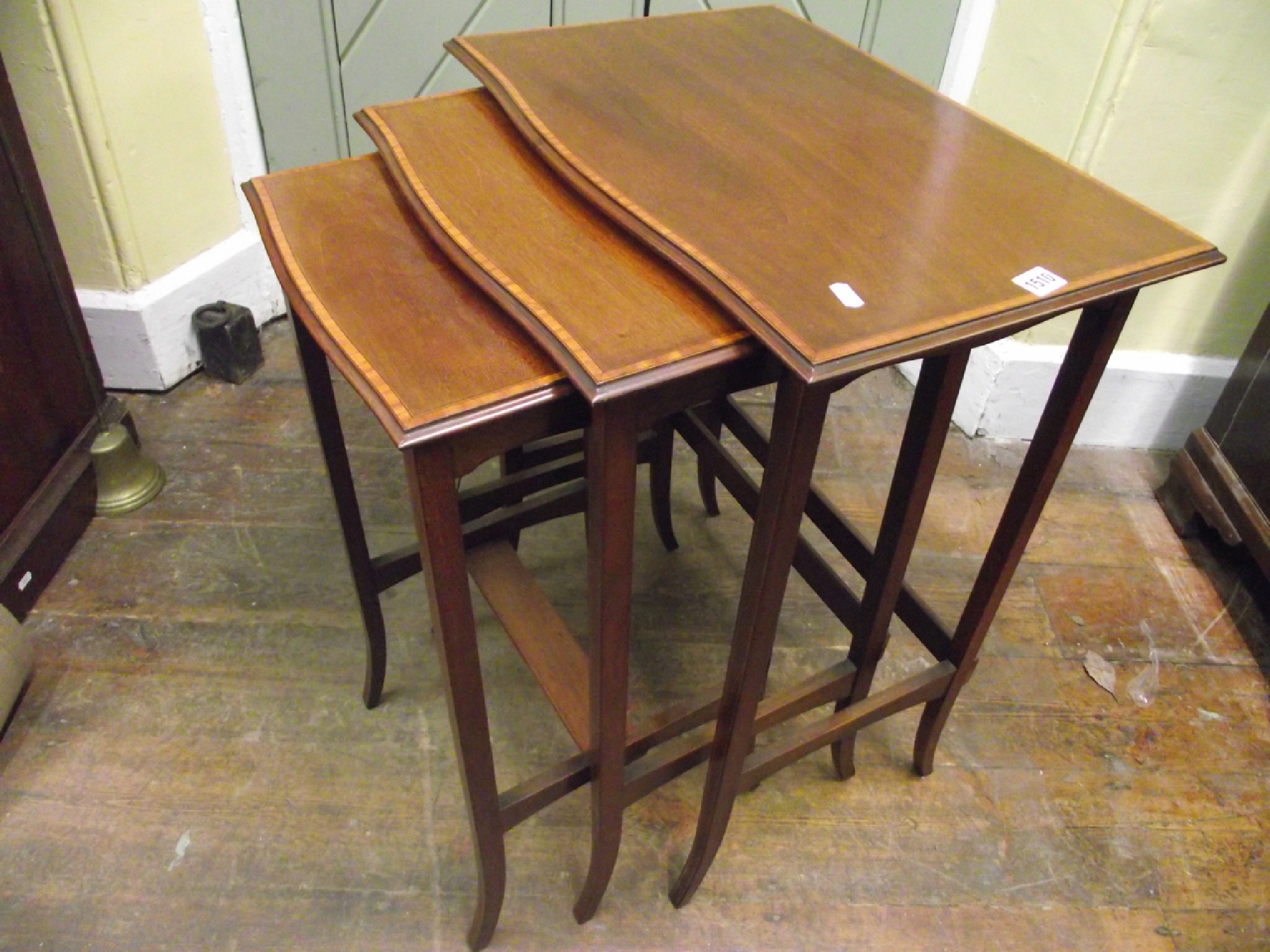 Appraisal: A nest of three inlaid Edwardian mahogany occasional tables crossbanded