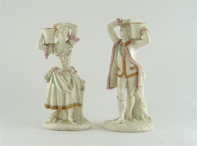 Appraisal: A pair of Royal Worcester candlestick figures modelled as a