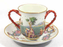 Appraisal: A cup and saucer with scenes in relief of lakeside