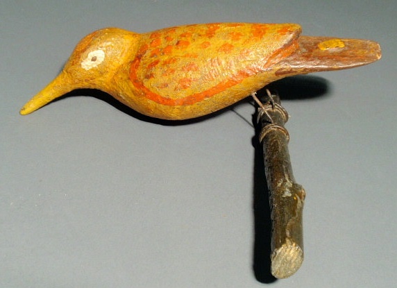 Appraisal: German folk art carved bird with yellow and orange paint