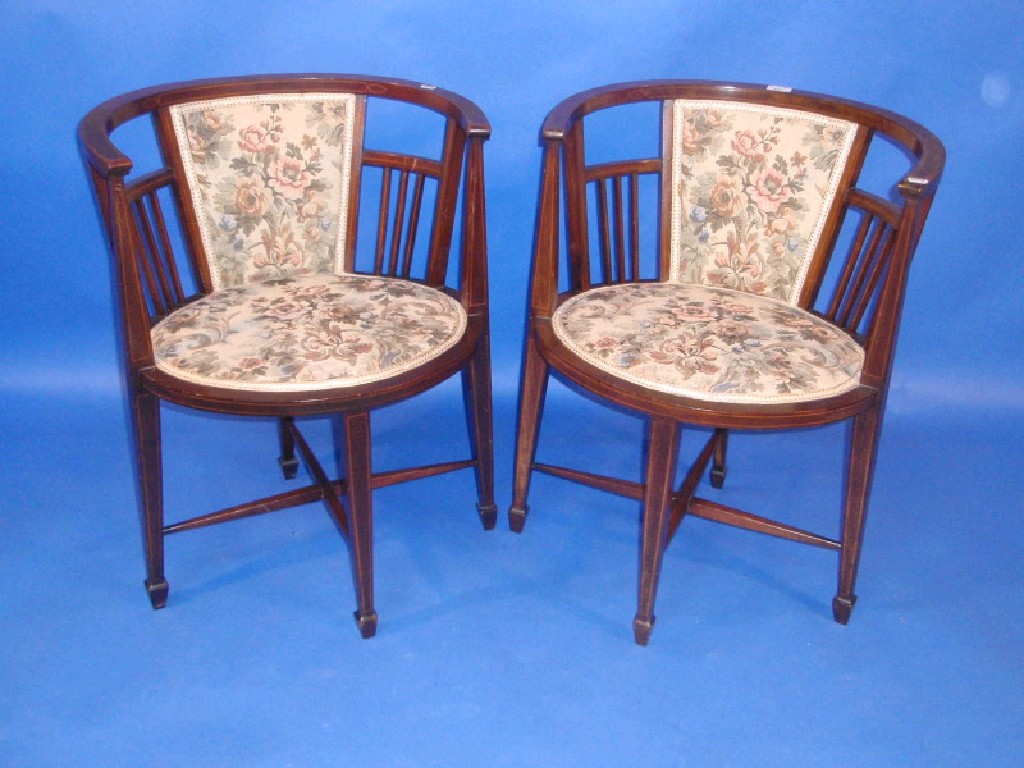 Appraisal: A pair of Edwardian string inlaid mahogany boudoir chairs with