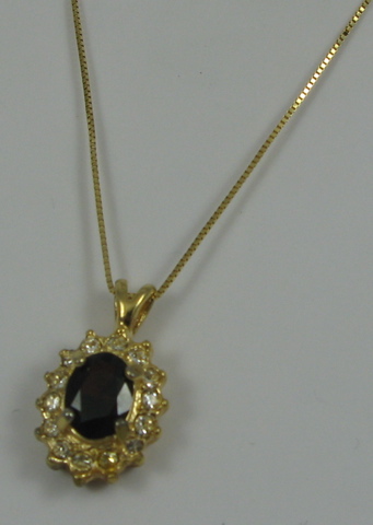 Appraisal: GARNET AND YELLOW GOLD PENDANT NECKLACE the pendant centering an