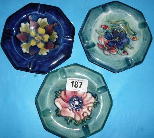 Appraisal: Moorcroft Ashtrays decorated in designs Spring Flowers Anemone and Columbine