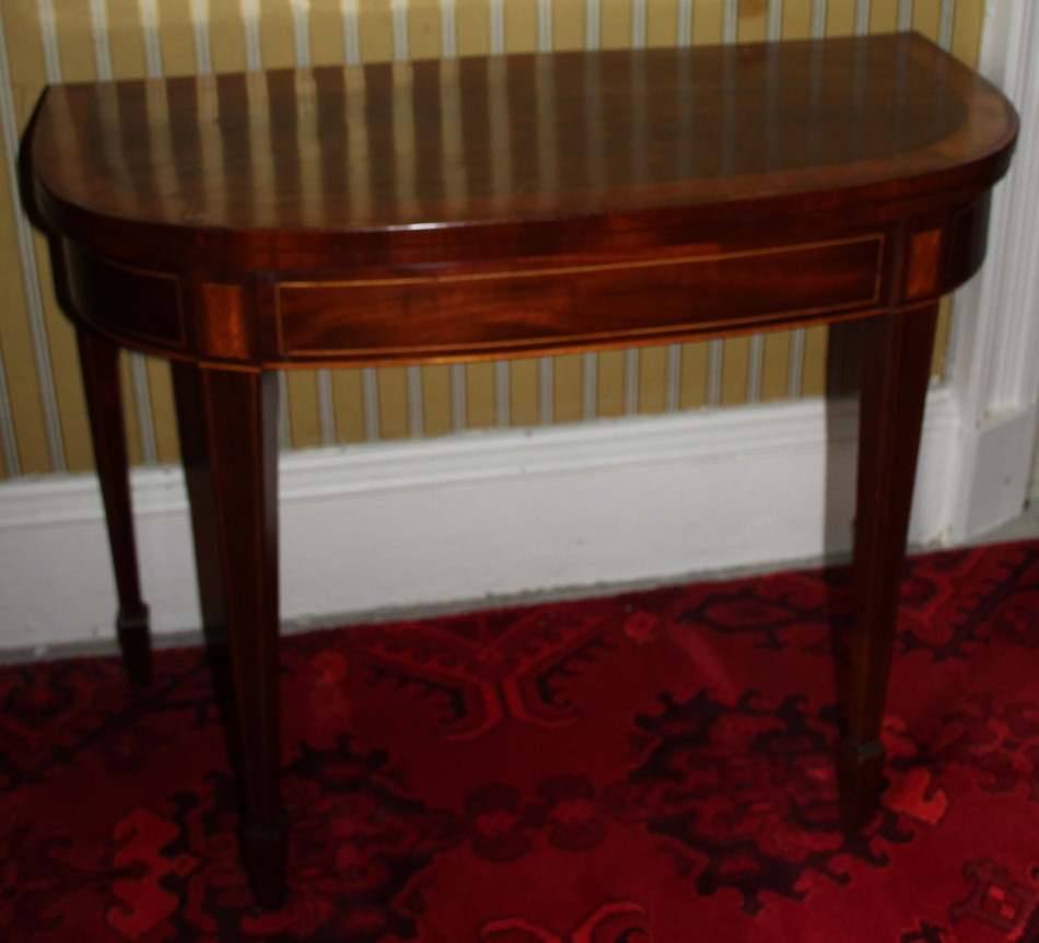 Appraisal: A George III mahogany and satinwood demi-lune card table the