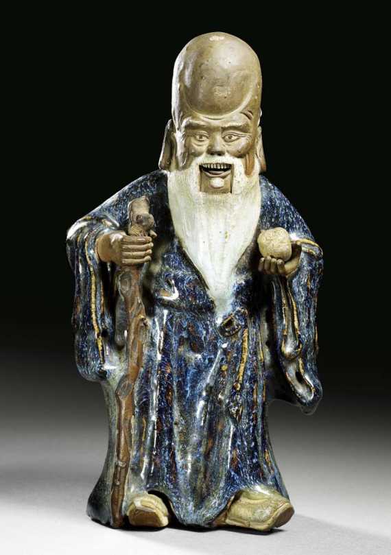 Appraisal: SHOU LAO China Shiwan-Ware th century H cm The garments