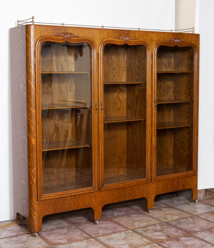 Appraisal: QUARTER SAWN OAK BOOK CASE Brass gallery triple door glass