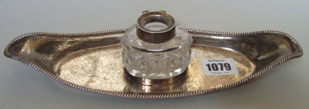 Appraisal: A silver shaped oval inkstand decorated with a gadrooned rim